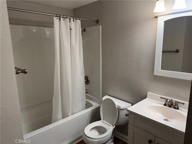 full bathroom featuring shower / bath combo with shower curtain, vanity, and toilet