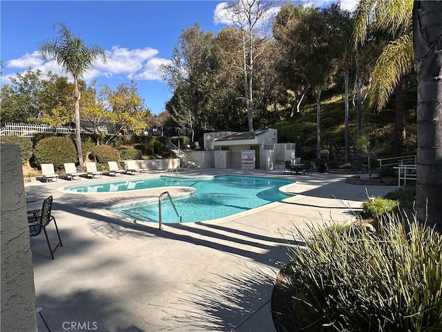 pool featuring a patio area and fence