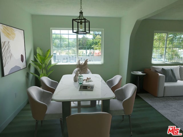 dining area with hardwood / wood-style floors and a notable chandelier