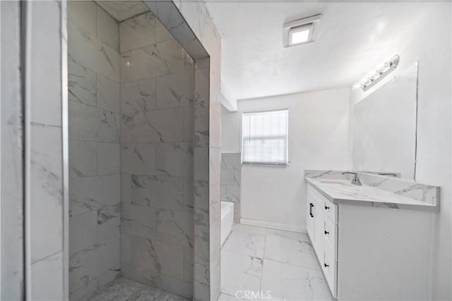 bathroom with vanity and tiled shower