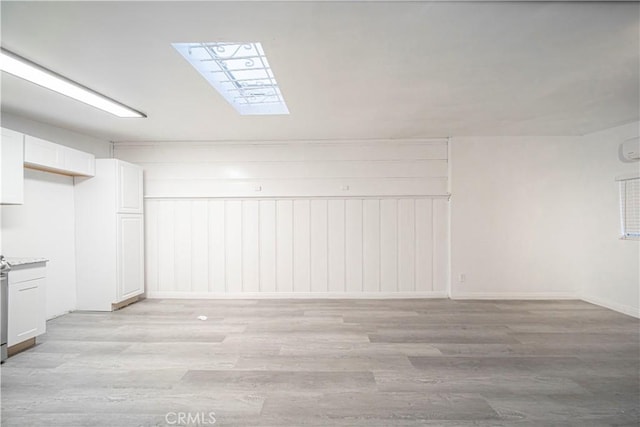 basement with light hardwood / wood-style floors