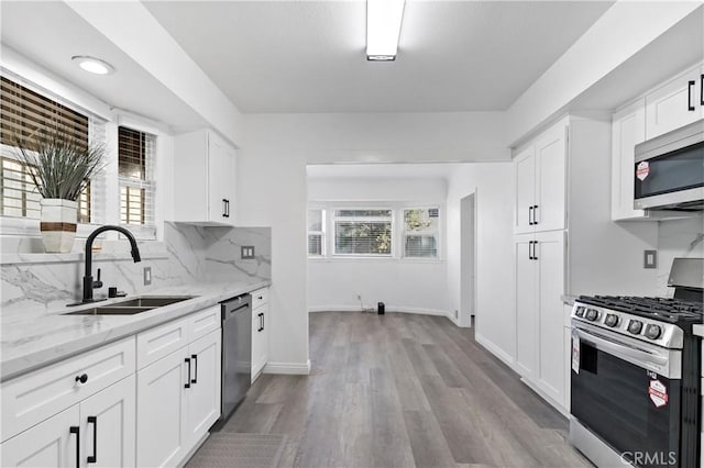 kitchen featuring white cabinets, appliances with stainless steel finishes, and sink