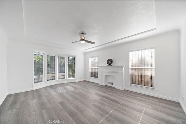 unfurnished living room featuring ceiling fan and light hardwood / wood-style floors