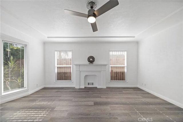 unfurnished living room with ceiling fan and wood-type flooring