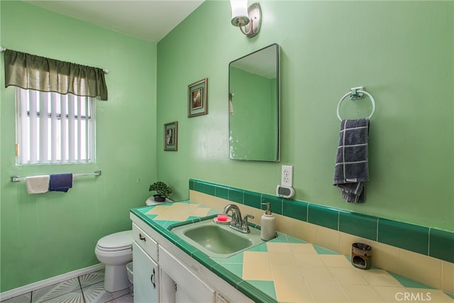 bathroom with tile patterned floors, vanity, and toilet