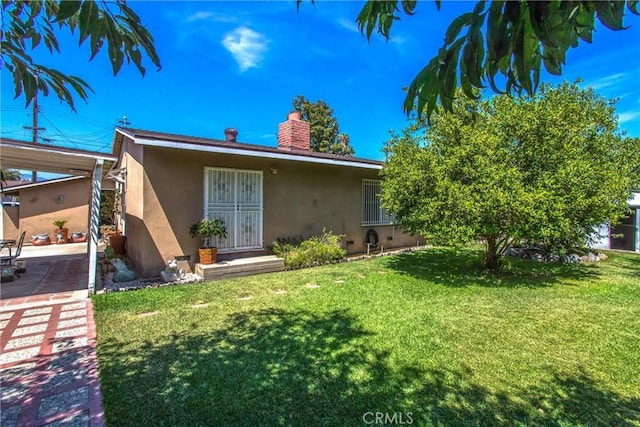 15937 Manzanita Dr, Fontana, CA 92335 - exterior space featuring stucco siding, a chimney, and a lawn