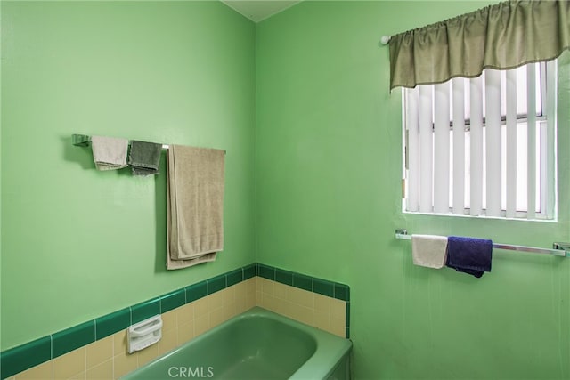 bathroom with a bathing tub and plenty of natural light