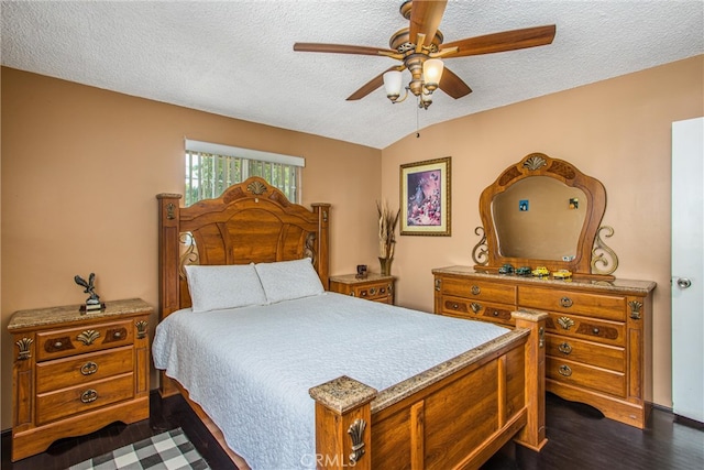 bedroom featuring a textured ceiling, lofted ceiling, ceiling fan, and dark hardwood / wood-style flooring