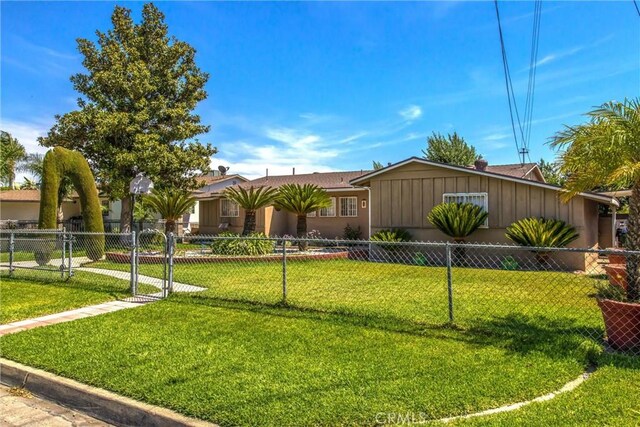 15937 Manzanita Dr, Fontana, CA 92335 - ranch-style house with a front lawn, board and batten siding, and fence