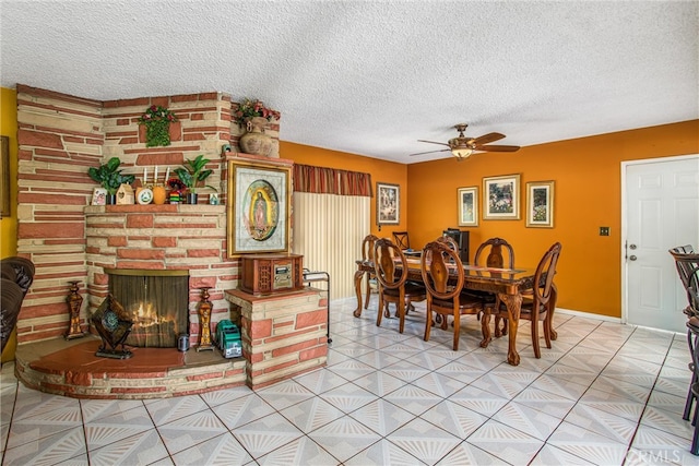 tiled dining area featuring a textured ceiling and ceiling fan