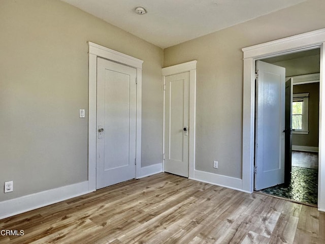 unfurnished bedroom with light wood-type flooring