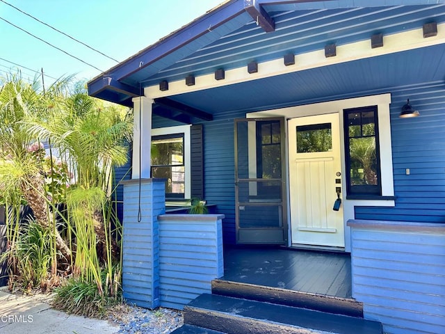 view of exterior entry featuring a porch