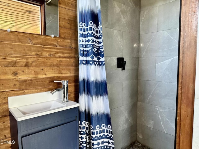 bathroom featuring vanity and wooden walls