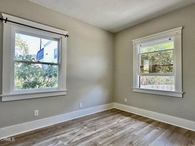 unfurnished room with light hardwood / wood-style floors