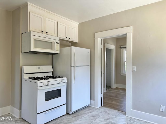 kitchen featuring white cabinets, white appliances, and light hardwood / wood-style floors