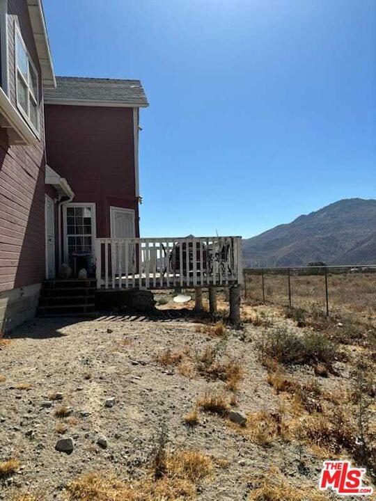 view of yard with a rural view and a mountain view