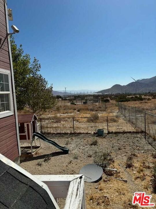 view of yard with a mountain view and an outdoor structure