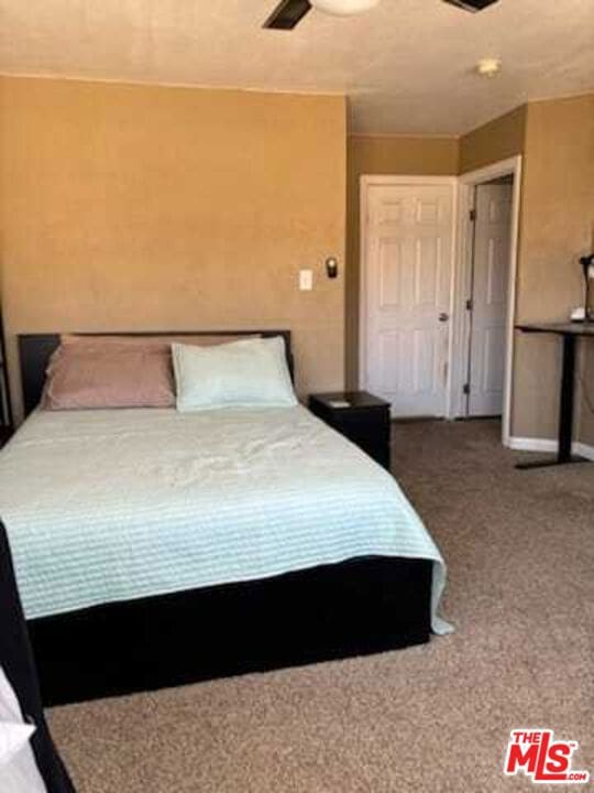 carpeted bedroom featuring ceiling fan