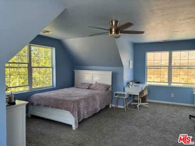 carpeted bedroom with ceiling fan, lofted ceiling, and multiple windows