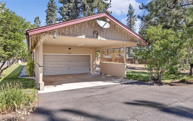 garage featuring a carport and a yard