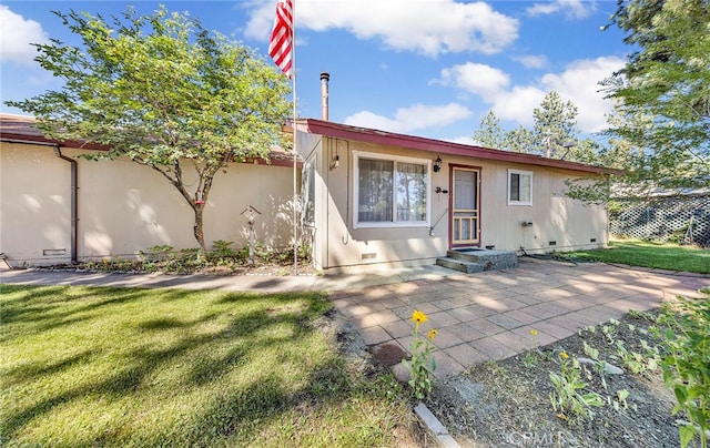 rear view of property featuring a lawn