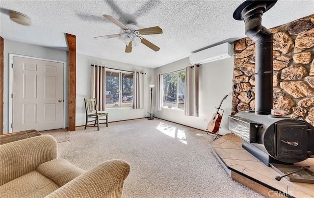 carpeted living room with a wood stove, a textured ceiling, ceiling fan, and a wall mounted air conditioner