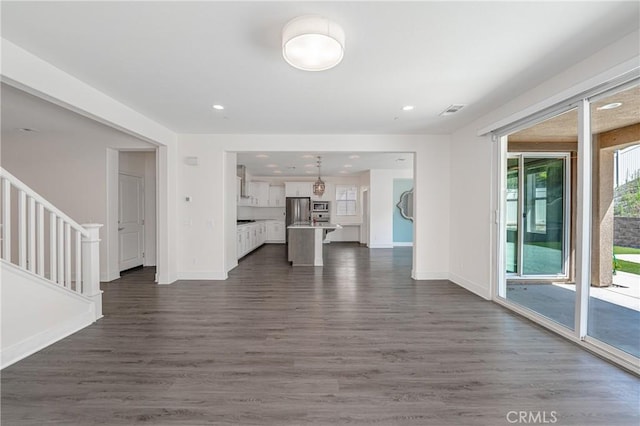 unfurnished living room with dark hardwood / wood-style flooring