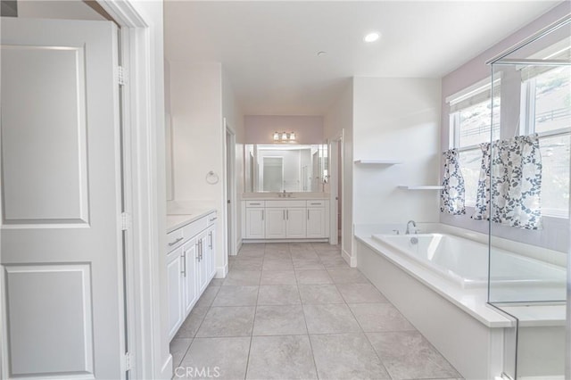 bathroom featuring tile patterned floors, vanity, and shower with separate bathtub