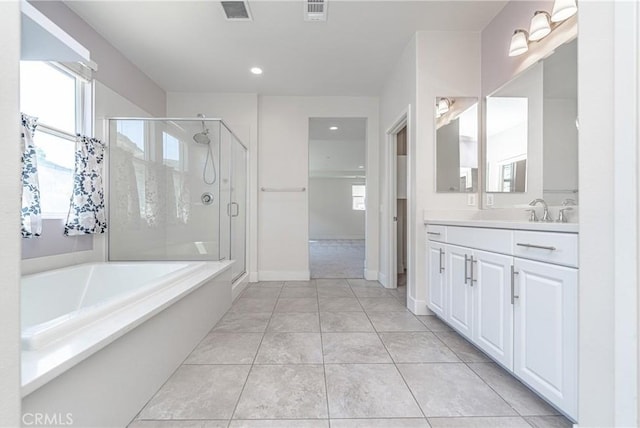 bathroom with tile patterned floors, vanity, and shower with separate bathtub