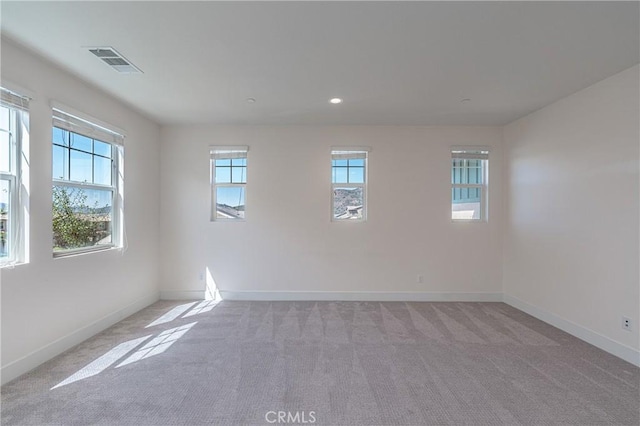 unfurnished room with light colored carpet