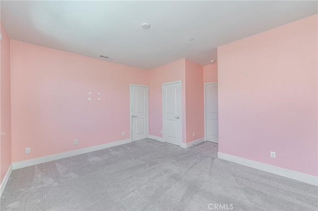 unfurnished room with light colored carpet