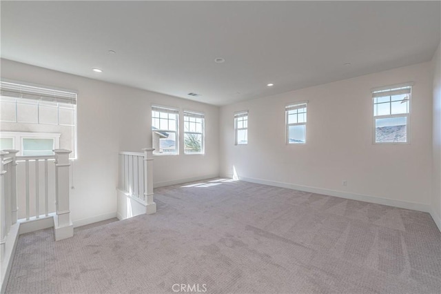 carpeted empty room featuring a healthy amount of sunlight