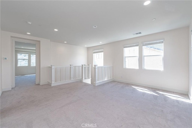 carpeted spare room with plenty of natural light