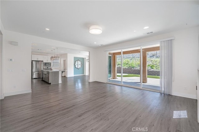 unfurnished living room featuring dark hardwood / wood-style flooring