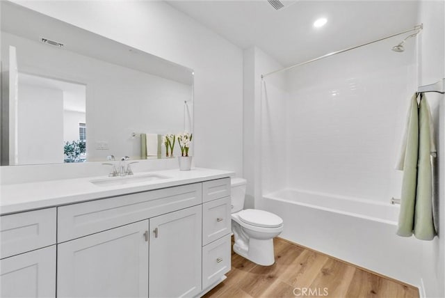 full bathroom featuring shower / tub combination, toilet, vanity, and hardwood / wood-style flooring