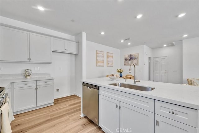 kitchen with dishwasher, white cabinetry, sink, and light hardwood / wood-style flooring