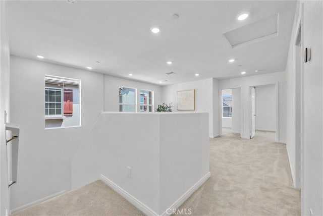 hall featuring light colored carpet