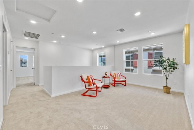 sitting room featuring light carpet