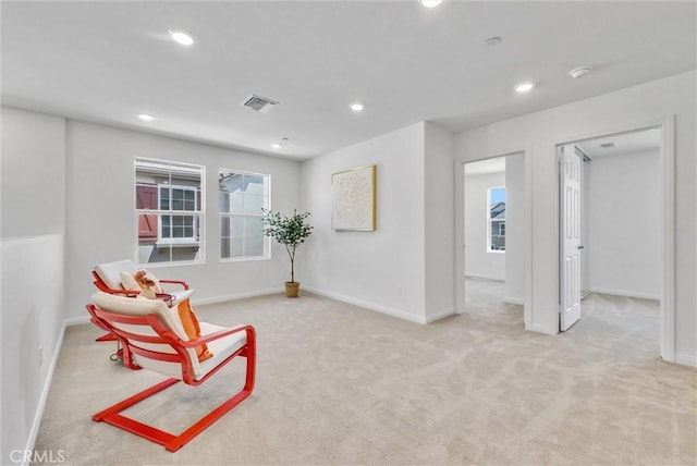 sitting room featuring light colored carpet