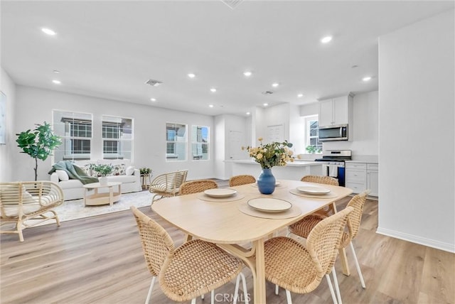 dining room with light hardwood / wood-style flooring