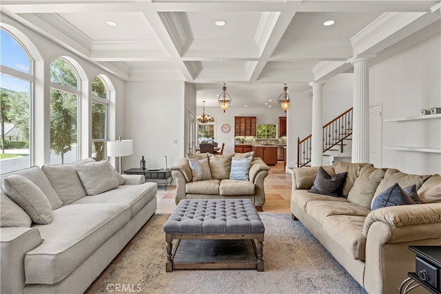 living room with light hardwood / wood-style floors, beamed ceiling, decorative columns, coffered ceiling, and crown molding