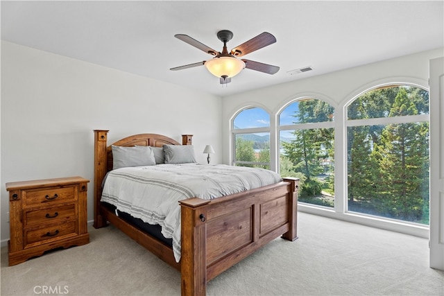 bedroom featuring ceiling fan and light colored carpet