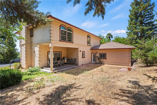 rear view of house featuring a patio area