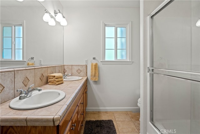 bathroom featuring decorative backsplash, vanity, toilet, and tile patterned floors