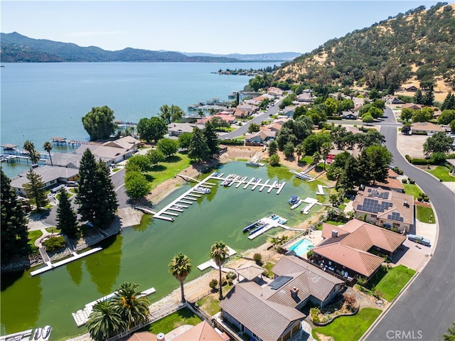 drone / aerial view featuring a water and mountain view