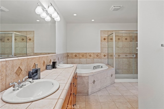 bathroom featuring tile patterned flooring, vanity, and plus walk in shower