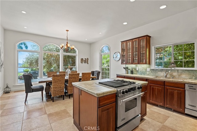 kitchen with decorative backsplash, stainless steel appliances, plenty of natural light, and sink