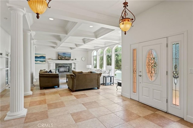 foyer entrance with a fireplace with raised hearth, recessed lighting, coffered ceiling, beamed ceiling, and ornate columns