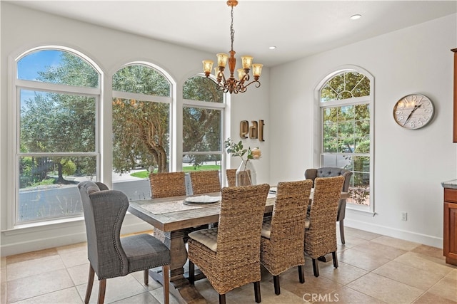 tiled dining space with an inviting chandelier