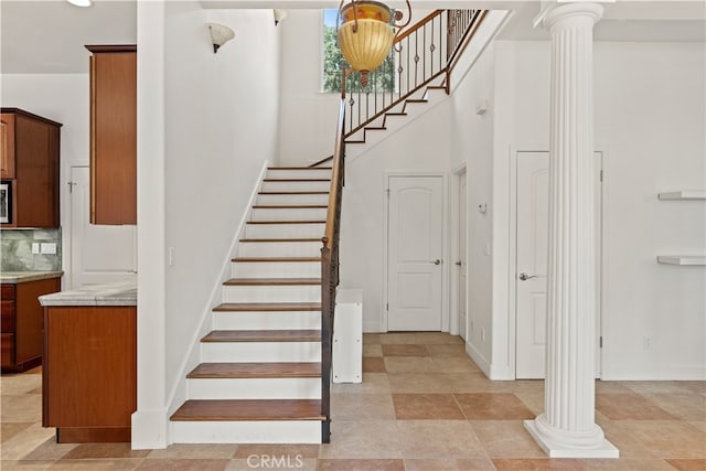 staircase featuring ornate columns